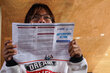 A person peer over a leaflet on 'Anticipatory Action'